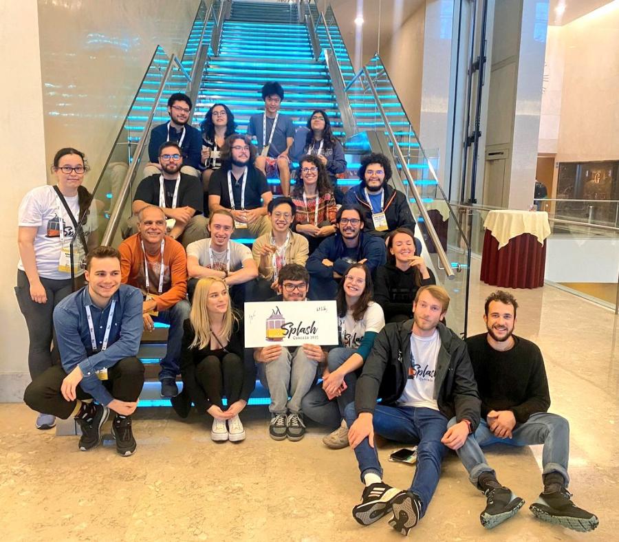 The SPLASH 2023 student volunteer team posing on a staircase with a SPLASH sign.